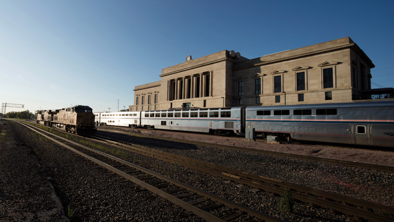 Trains passing behind 7 Burlington Station, designed by LEO A DALY